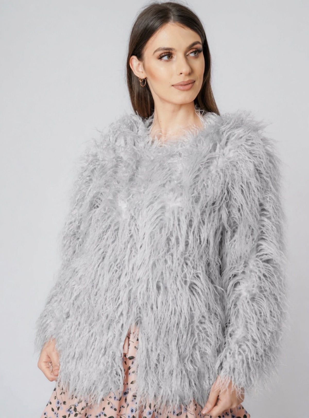 Light grey shaggy faux fur coat jacket worn over a floral dress
