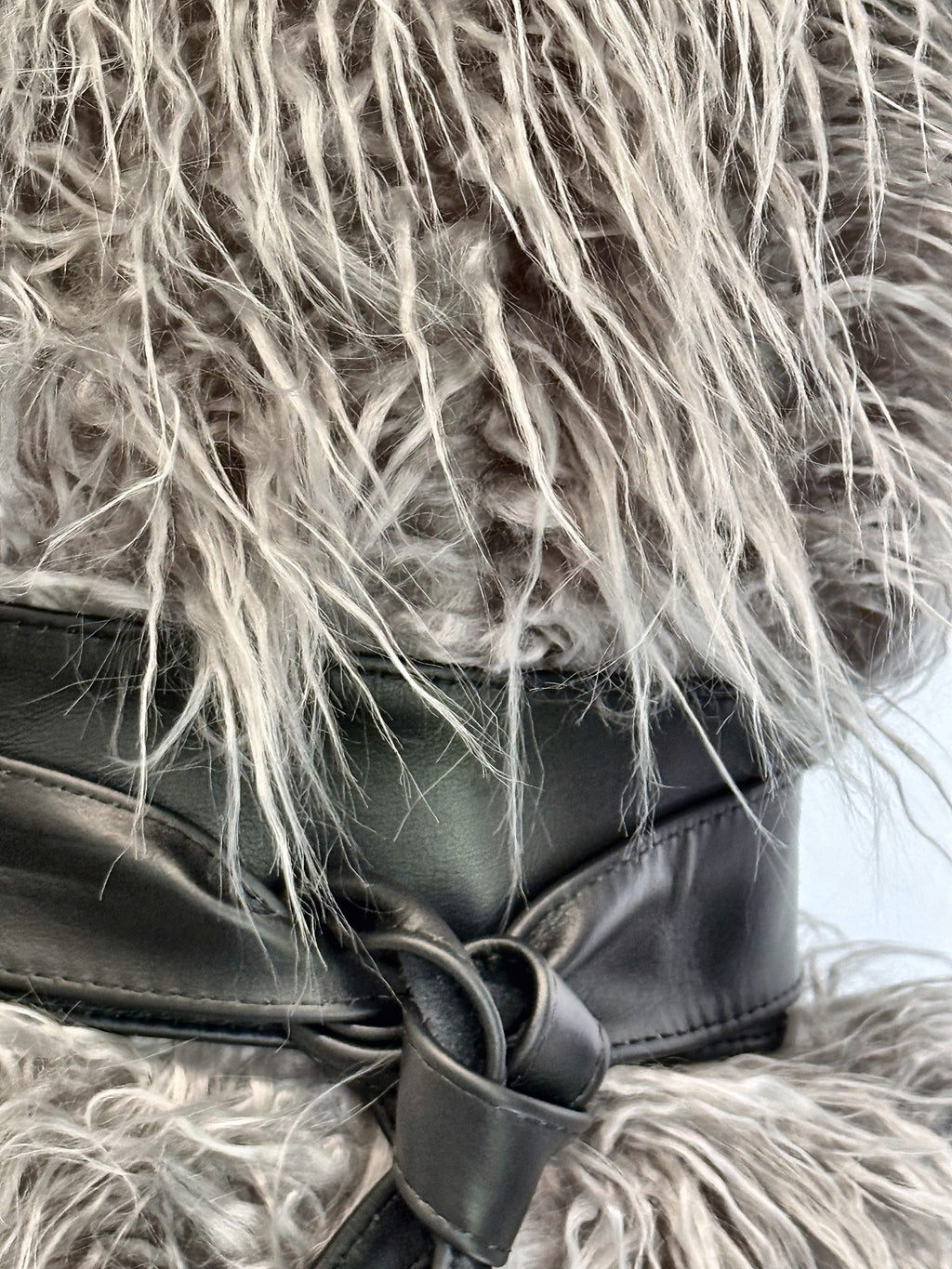 Black real leather obi sash belt knotted over fluffy grey faux fur