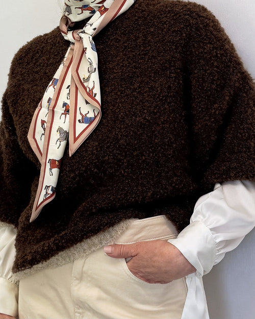 Close-up of the chocolate brown bouclé jumper with cream bouclé trim, styled with a silk scarf and white shirt
