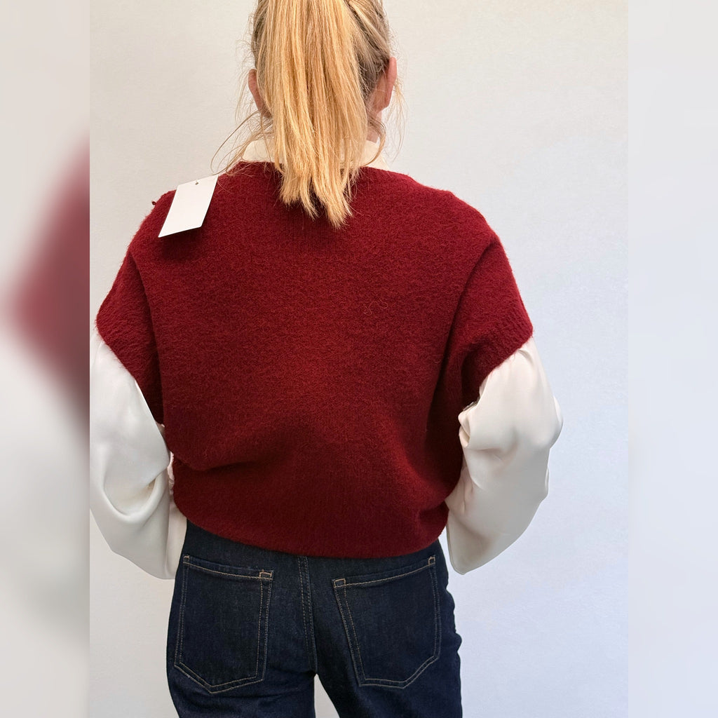 Burgundy knit tank top worn over a white shirt, back