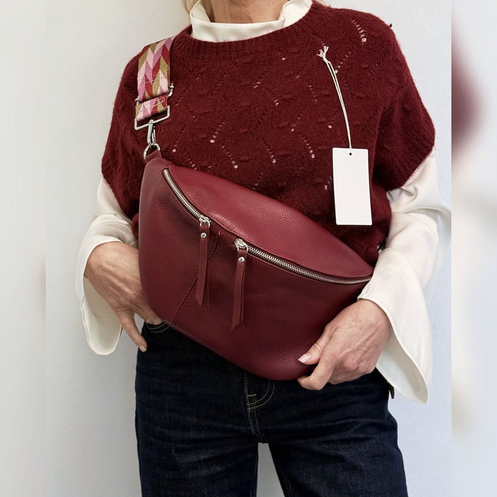Burgundy knit tank top styled with a burgundy leather bag
