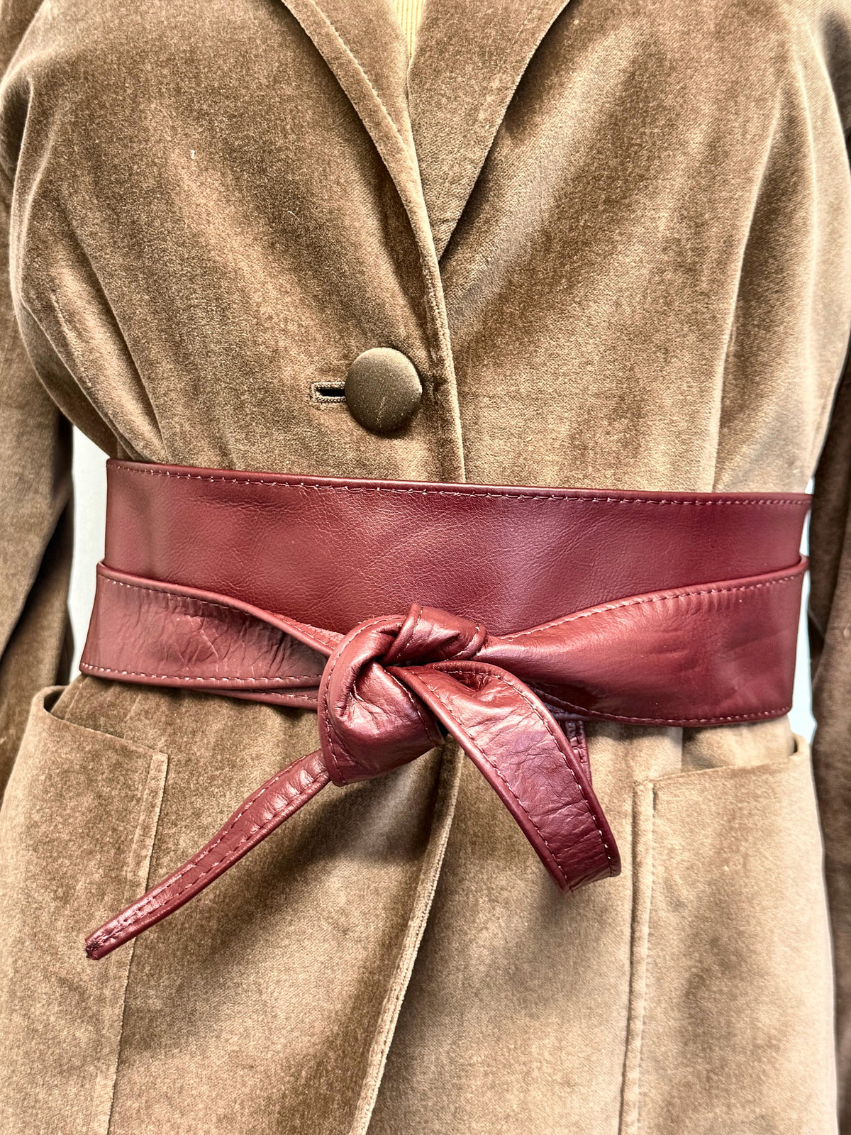 Burgundy real leather wide obi sash belt tied over a camel velvet blazer