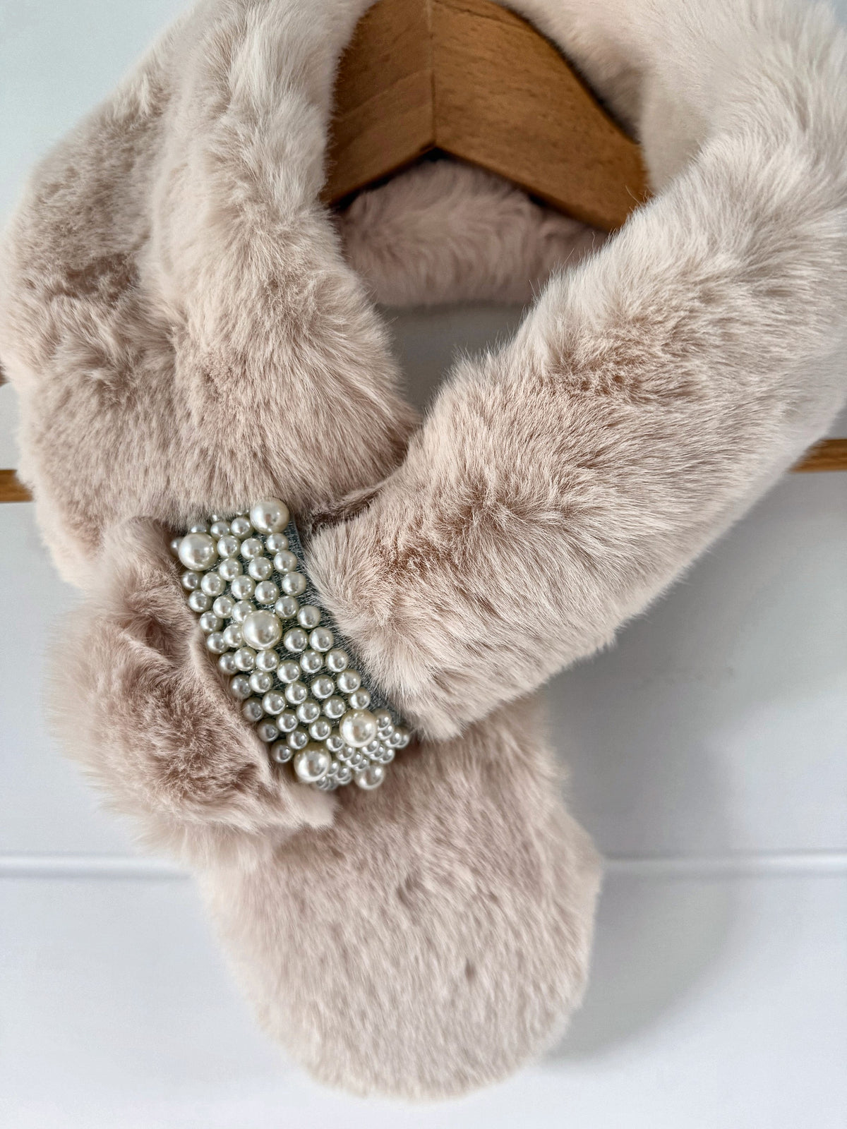 Cream ivory faux fur neck warmer fastened through the pearl loop brooch