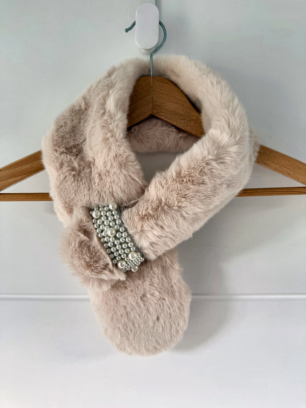 Cream ivory faux fur neck warmer scarf wrap on a hanger