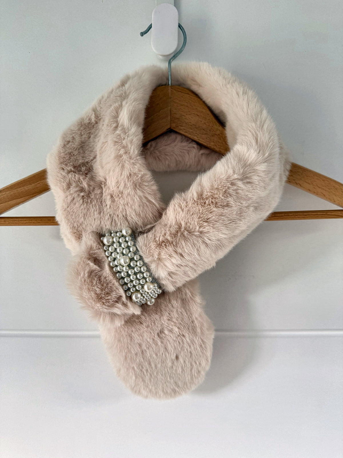 Cream ivory faux fur neck warmer scarf wrap on a hanger