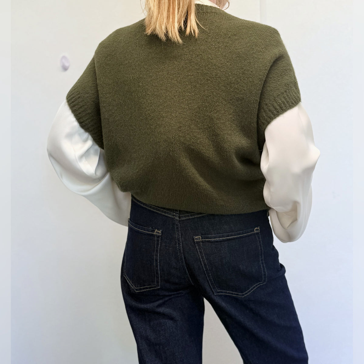Khaki Forest Green knit tank top worn over a white shirt, back