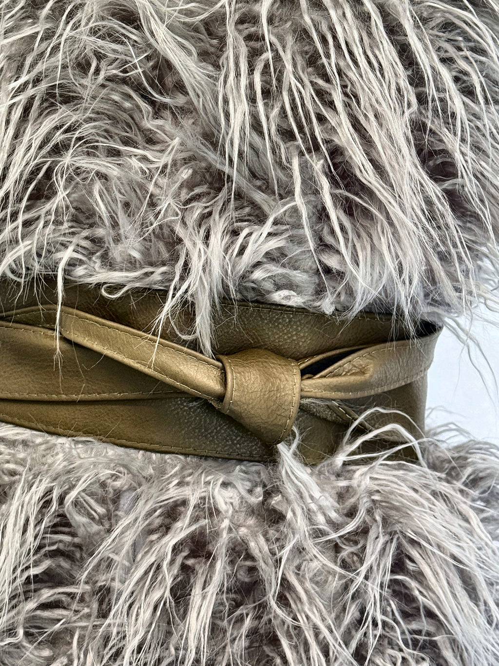 Olive Khaki Green leather obi sash belt cinching a grey faux fur gilet