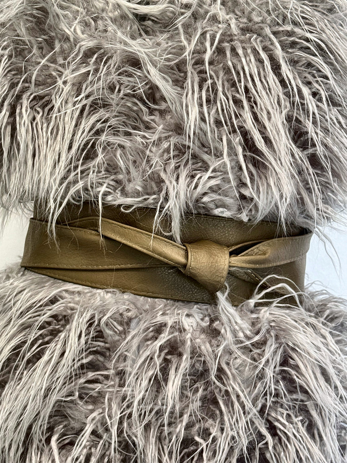 Olive Khaki Green real leather obi belt tied over a fluffy grey faux fur gilet