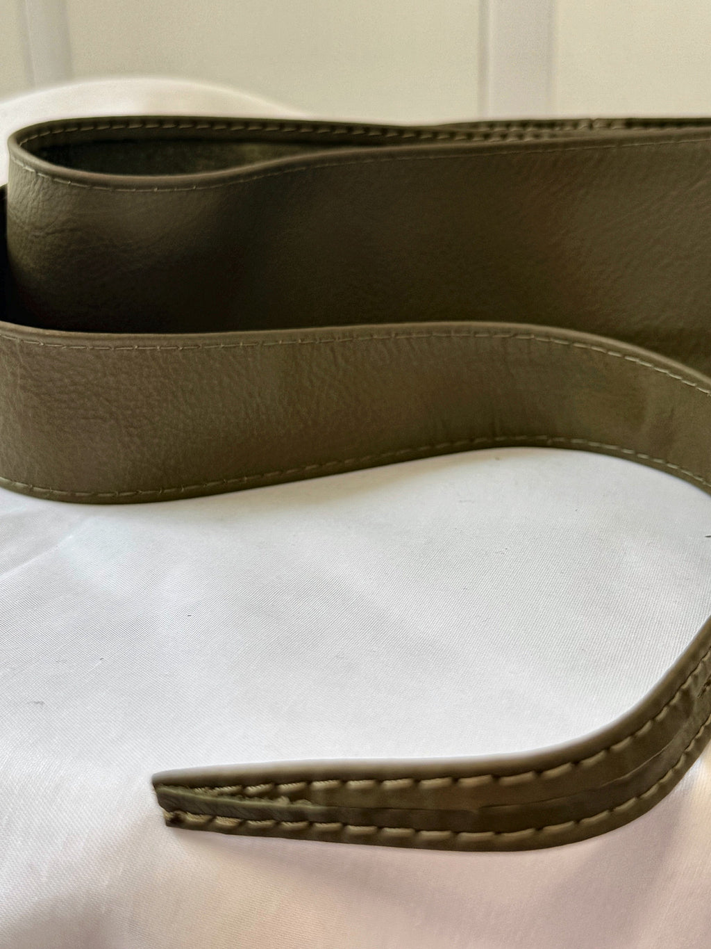 Olive Khaki Green leather obi belt end showing the stitched edge