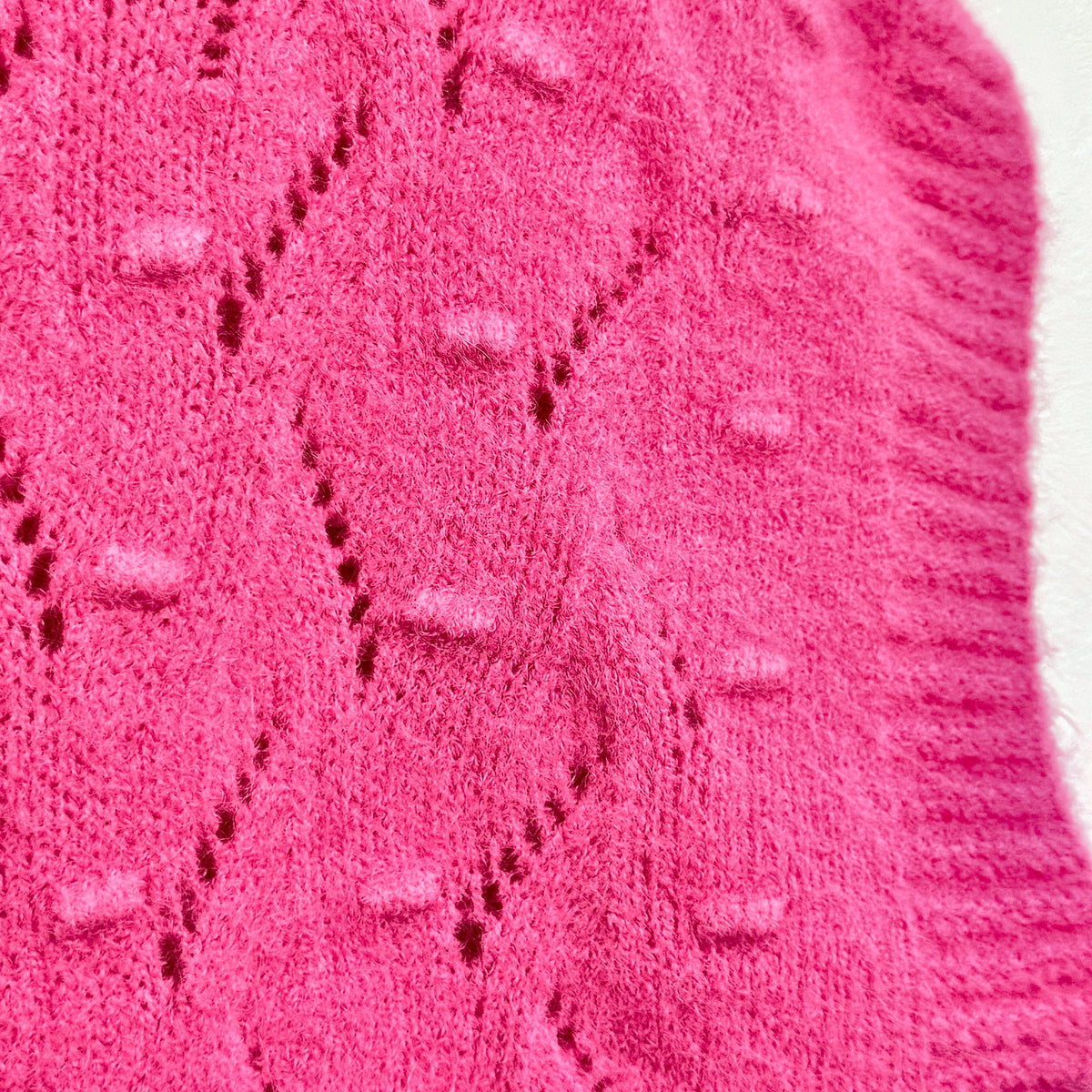 Close-up of Hot Pink bobble and pointelle knit texture